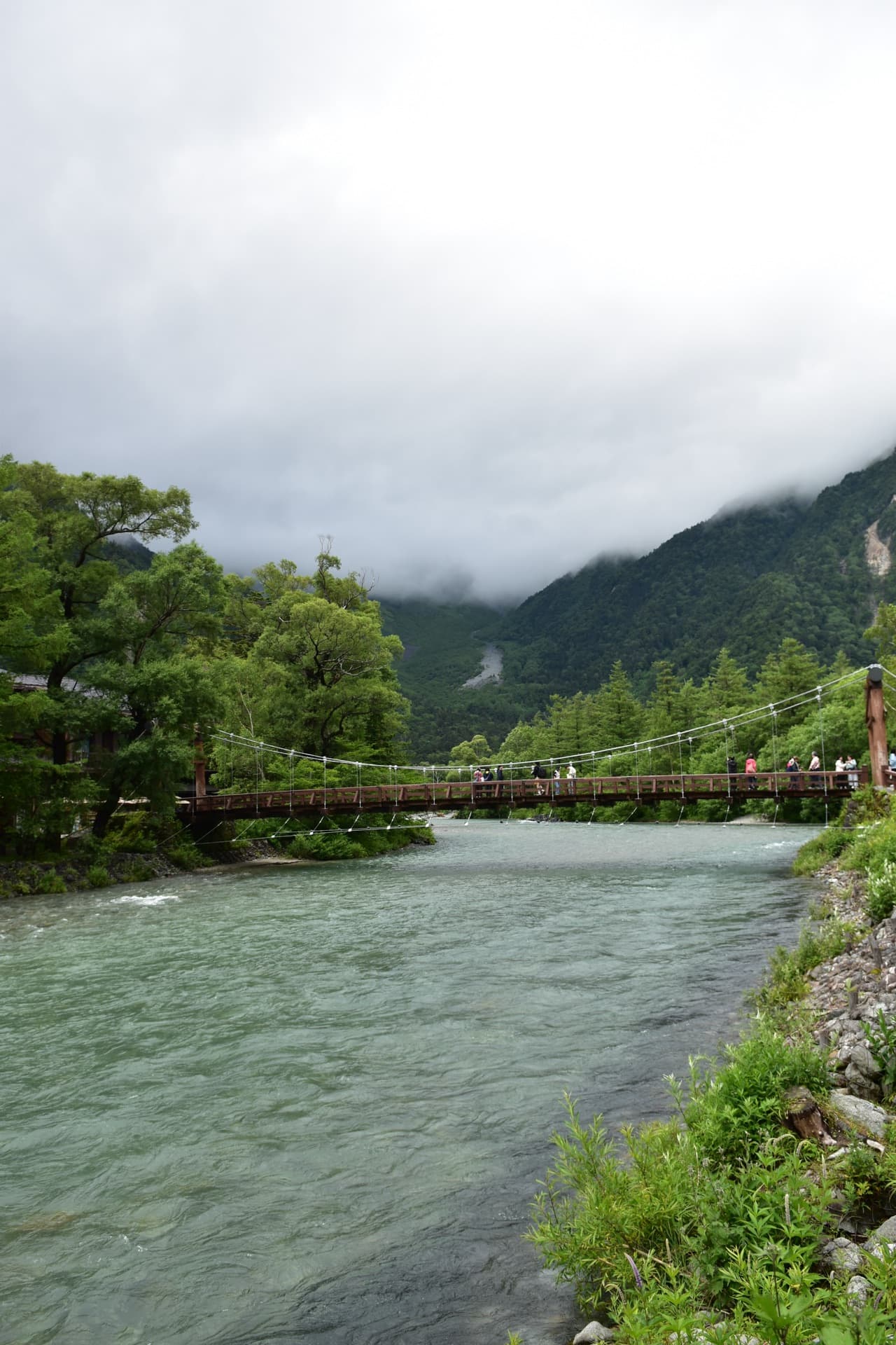 Misty peaks and an emerald river