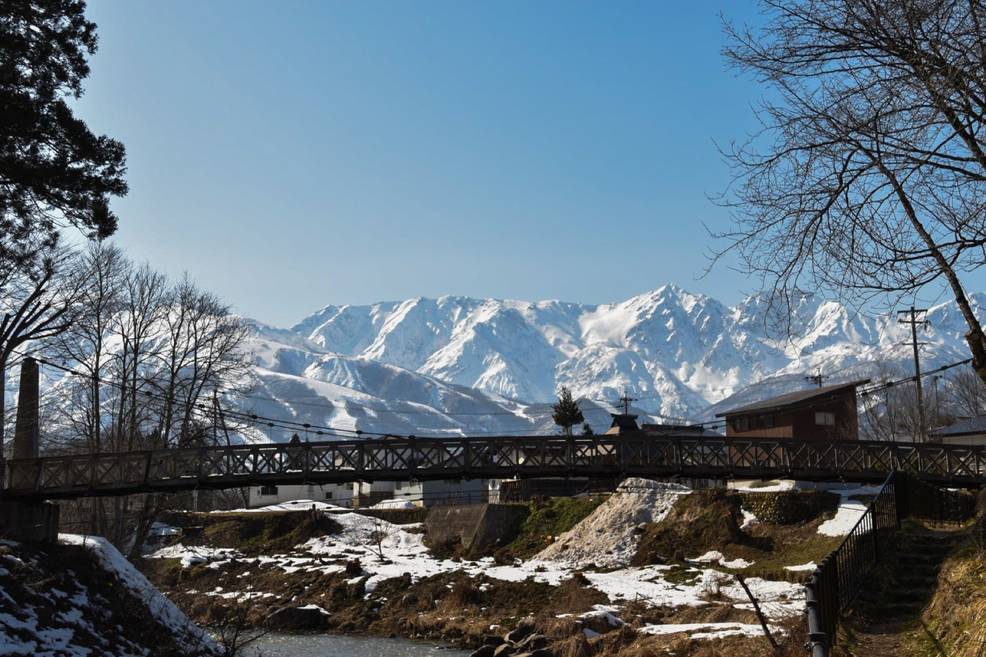 Stopping by a bridge under snow-covered peaks
