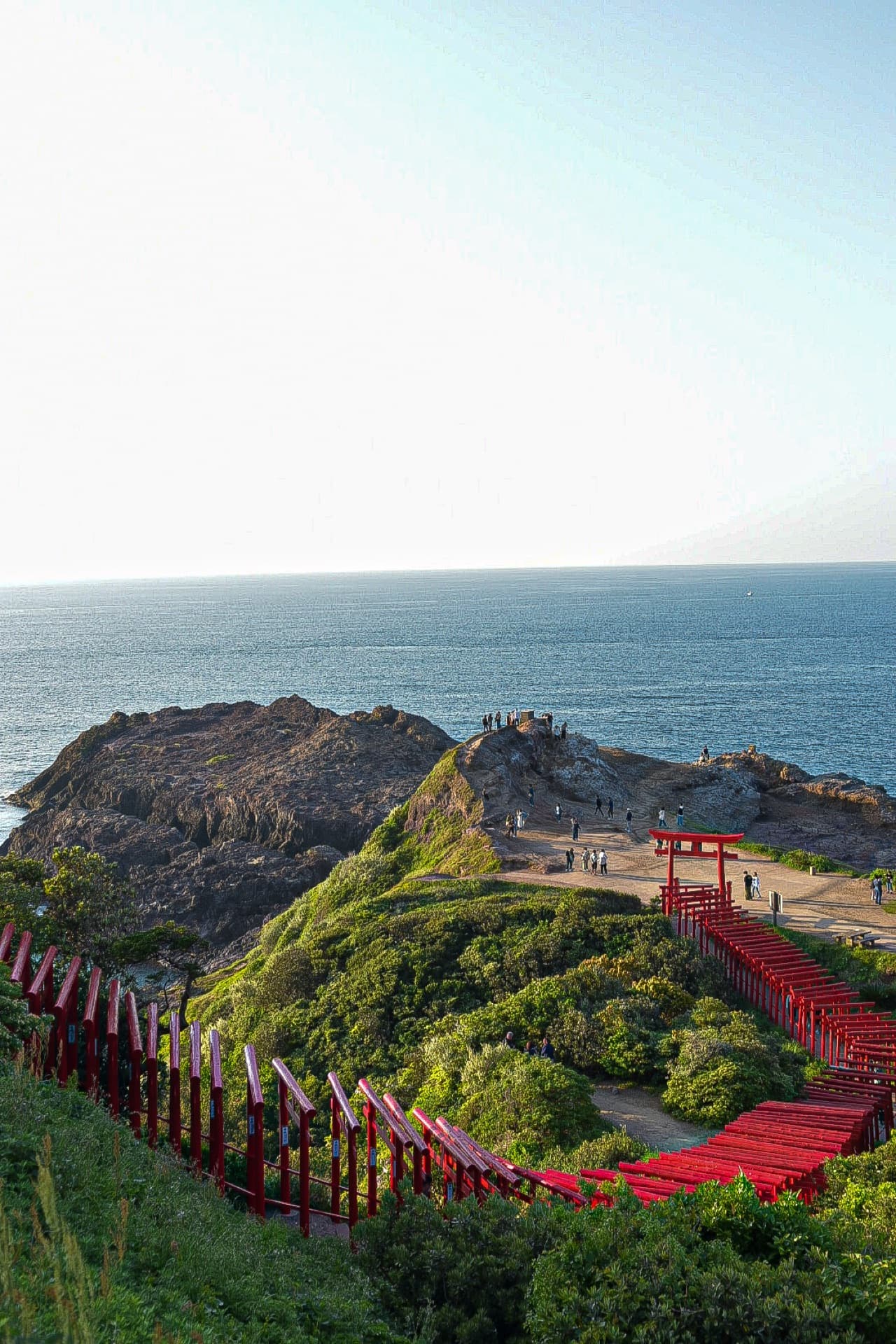 Red torii gates walking all the way to the sea